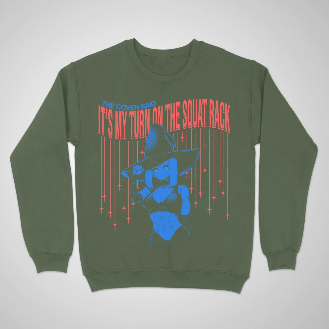 Military green crewneck sweatshirt with an anime witch and "It's My Turn on the Squat Rack" lettering on the front.