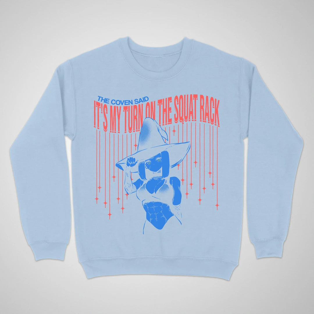 Light blue crewneck sweatshirt with an anime witch and "It's My Turn on the Squat Rack" lettering on the front.