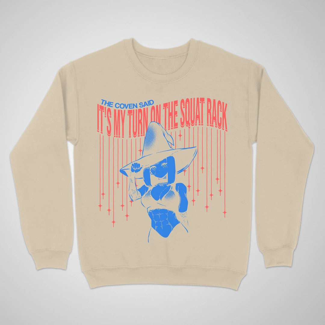 Sand crewneck sweatshirt with an anime witch and "It's My Turn on the Squat Rack" lettering on the front.
