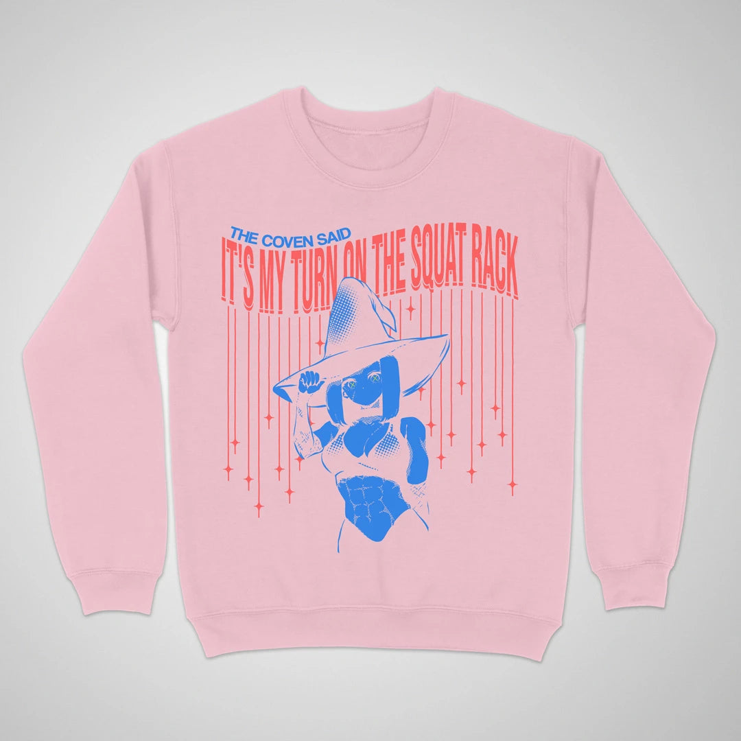 Light pink crewneck sweatshirt with an anime witch and "It's My Turn on the Squat Rack" lettering on the front.